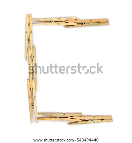 Letter C made of wooden clothespins isolated on white