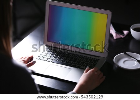 Woman working with laptop in cafe