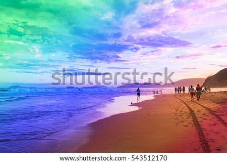 Adult people walking on a beach on sunny day. Young boys and girl enjoying a summer day in tropical paradise for travel, lifestyle business concept, blog, magazine. Image with rainbow color filter