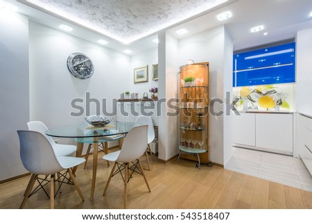 Dining room and kitchen in modern apartment interior