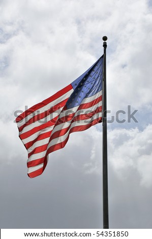 Large flag waving in a cloudy sky