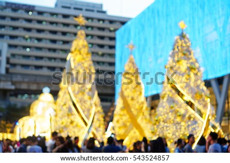 Blurred Photo - Christmas tree with many people at Bangkok, Thailand. New Year Celebration concept. Abstract background