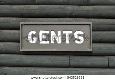 Gents toilet sign on the wood wall 