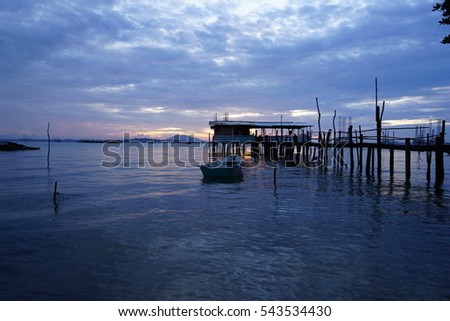 serene view of an old jetty facing the sunrise