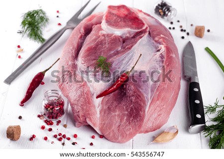 piece of pork on a bone with spices on wood e background. Space for text