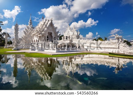 Wat Rong Khun The White Temple and pond with fish, in Chiang Rai, Thailand Royalty-Free Stock Photo #543560266