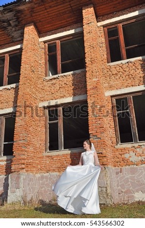 Bride near the brick house ruins