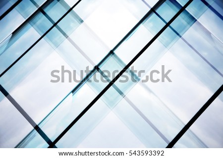 Reworked tilt photo of glass walls of office building. Abstract modern architecture background with geometric structure. Royalty-Free Stock Photo #543593392