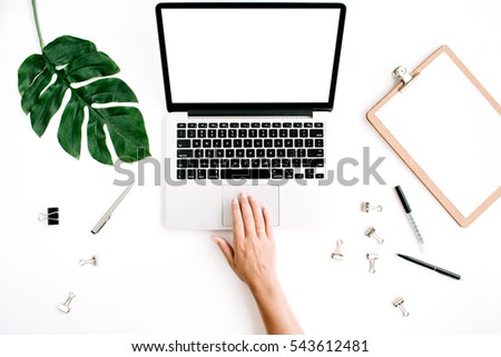 Workspace with woman working on laptop with blank screen. Flat lay, top view. Woman entrepreneur background with laptop