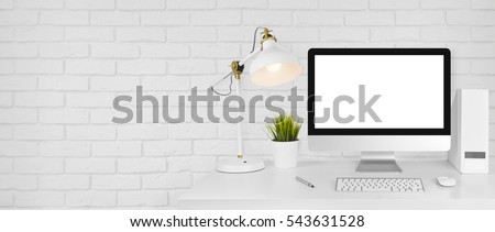 Design studio concept with workplace and white brick wall background