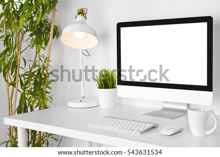 Modern creative designer workplace with desk computer on white table
