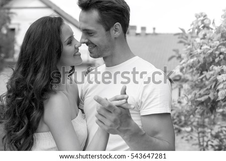 Romantic young couple dancing in park