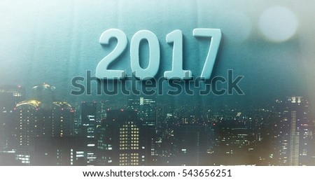 Double exposure of city and happy new year 2017 alphabet with bokeh