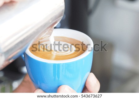 Cup of coffee latte in coffee shop