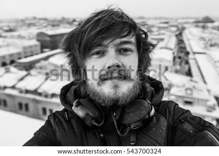 portrait of young guy with beard and headphones