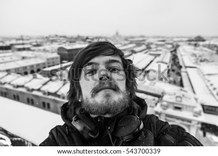 portrait of young guy with beard and headphones