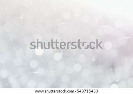 Abstract bokeh background with glitter effect in soft light silver tone