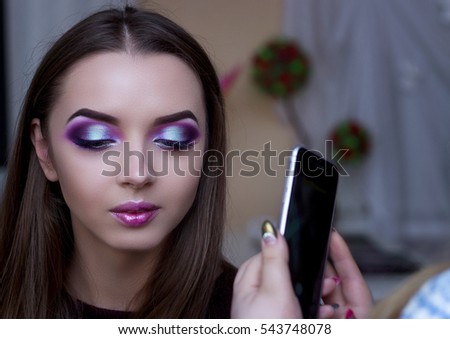 Photographing phone professional makeup. The girl's face with makeup. Photos for your mobile phone. Portrait of a girl. Royalty-Free Stock Photo #543748078