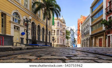 View of the historic Rua do Bom Jesus street in the city of Recife in Pernambuco, Brazil on a sunny summer day with its cobblestones and 17th century buildings. Royalty-Free Stock Photo #543755962