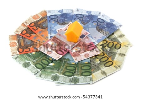 Plastic toy houses on money, isolated on white