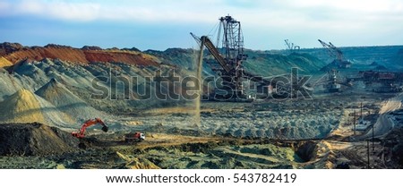 Open pit. Opencast manganese ore mine. Giant excavator machinery. Extractive industry. Big mine, develop mineral resources, excavator digs, metallurgy in Ukraine Royalty-Free Stock Photo #543782419