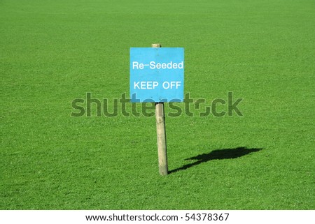 Green grass with a sign 're-seeded'