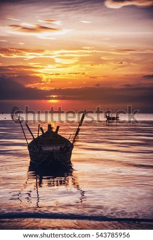 Beautiful sunset with fishing boat, vintage tone 