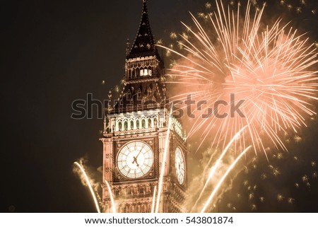 explosive fireworks display fills the sky around Big Ben. New Year's Eve celebration background