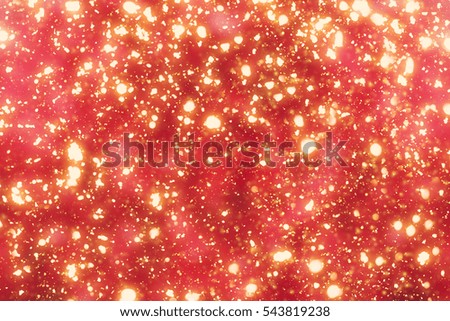 Red  Abstract Christmas Background with Rays and Golden circle glitter or bokeh lights. Round gold defocused particles