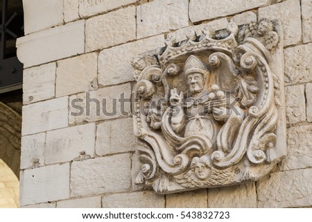 chiseled picture of Saint Nicholas on the Wall of Basilica of Saint Nicholas in Bari , Italy