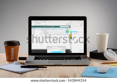 Chatting in the Internet for an employee to upgrade working skills. Modern laptop with the wi-fi connection for work. Two cups of delicious coffee in the right and left corners.