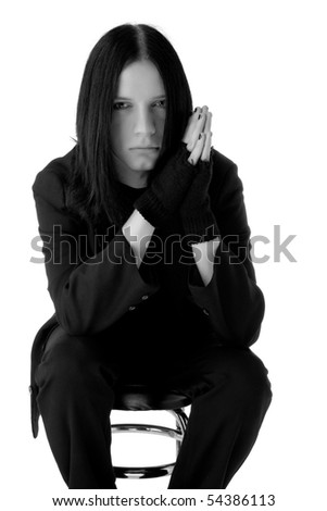 Young gothic man sitting on a bar chair