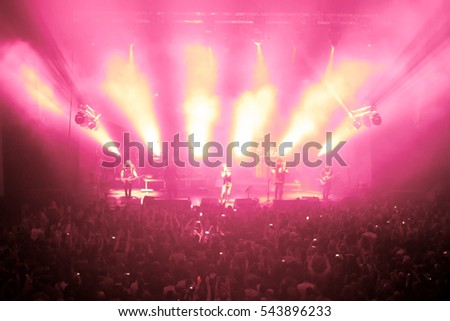 High resolution abstract motion blurred background glowing circle in the dark bright pink and white with blurred luminous rays up, picture of rock concert, music festival, New Year eve celebration