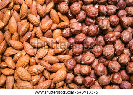 Peeled almonds and hazelnuts background or texture Royalty-Free Stock Photo #543913375
