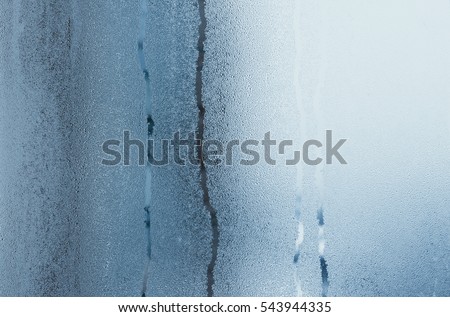 Condensation on the windows strong, high humidity in the room, cold tone Royalty-Free Stock Photo #543944335