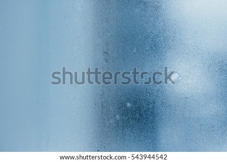 Condensation on the windows a strong, high humidity in the room, large water droplets flow down, cold tone Royalty-Free Stock Photo #543944542