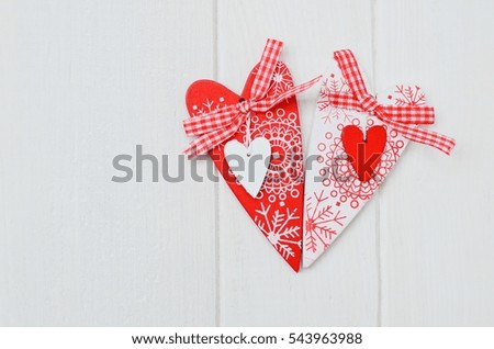Red and white handmade hearts on white wooden background. Copy space.