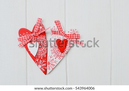 Red and white handmade hearts on white wooden background. Copy space.