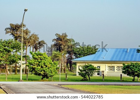School building surrounded by park on an oil company camp on Bonny Island, Nigeria