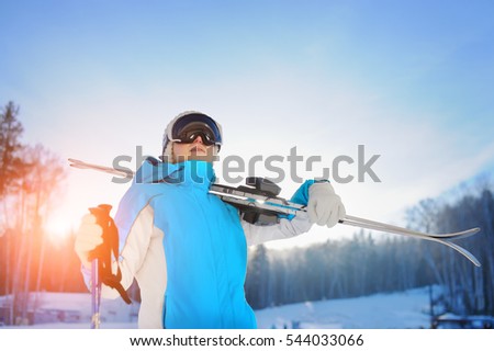 Woman Smiling And Holding Skiing. The Ski Resort