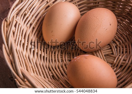 Three eggs in a brown wicker basket