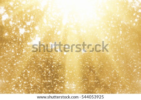 Golden rays and sparkles or glitter lights. Merry Christmas festive gold background.defocused circle bokeh or particles Royalty-Free Stock Photo #544053925