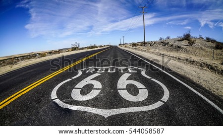 U.S. Route 66 highway, with sign on asphalt. Located in the mojave dessert Royalty-Free Stock Photo #544058587