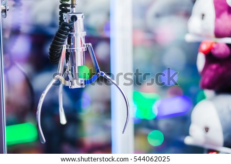 A mechanical arm selecting a random soft toy in a vending machine. Royalty-Free Stock Photo #544062025