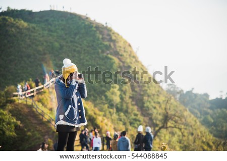 girl take photo at mountain