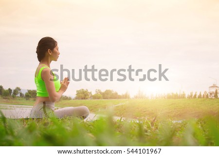 Yoga in the park, outdoor with effect light, health woman, Yoga woman. Concept of healthy lifestyle and relaxation. Meditation.