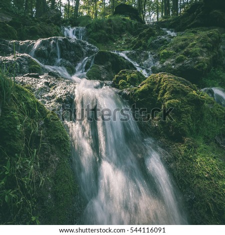 rocky waterfall in summer with stream and low water in forest - instant vintage square photo