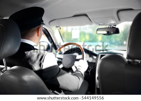 Chauffeur driving a car, view from inside Royalty-Free Stock Photo #544149556