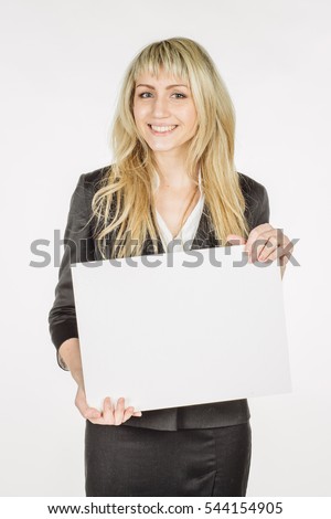 Portrait of young business woman holding a blank banner. image on a white studio background. business and lifestyle concept