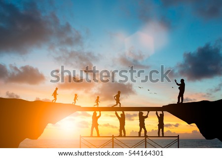 Silhouette  team responsible helped build the foundation for a child to grow up and grow efficiently over blurred natural. Royalty-Free Stock Photo #544164301